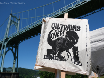St. Johns Bridge in Portland, Oregon, with protest sign that reads, "Oil Trains are So Over!"